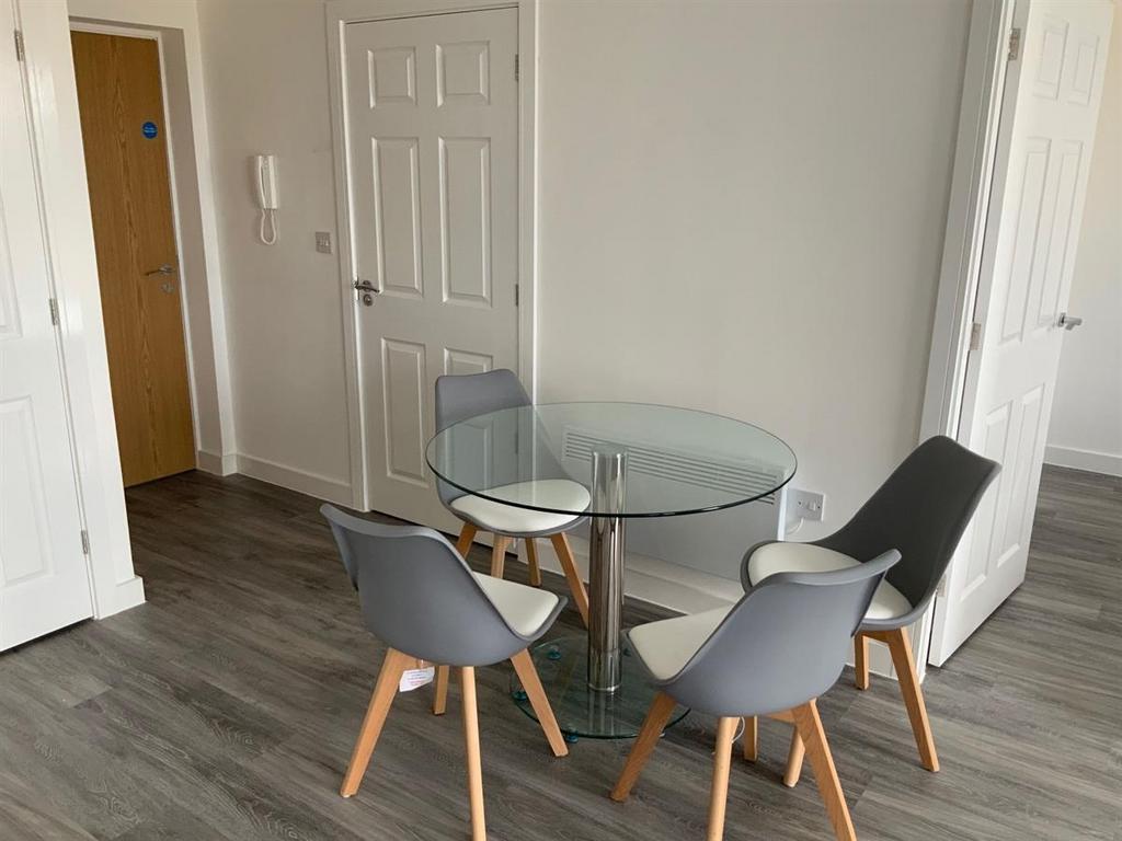 Modern dining area with glass table and stylish...