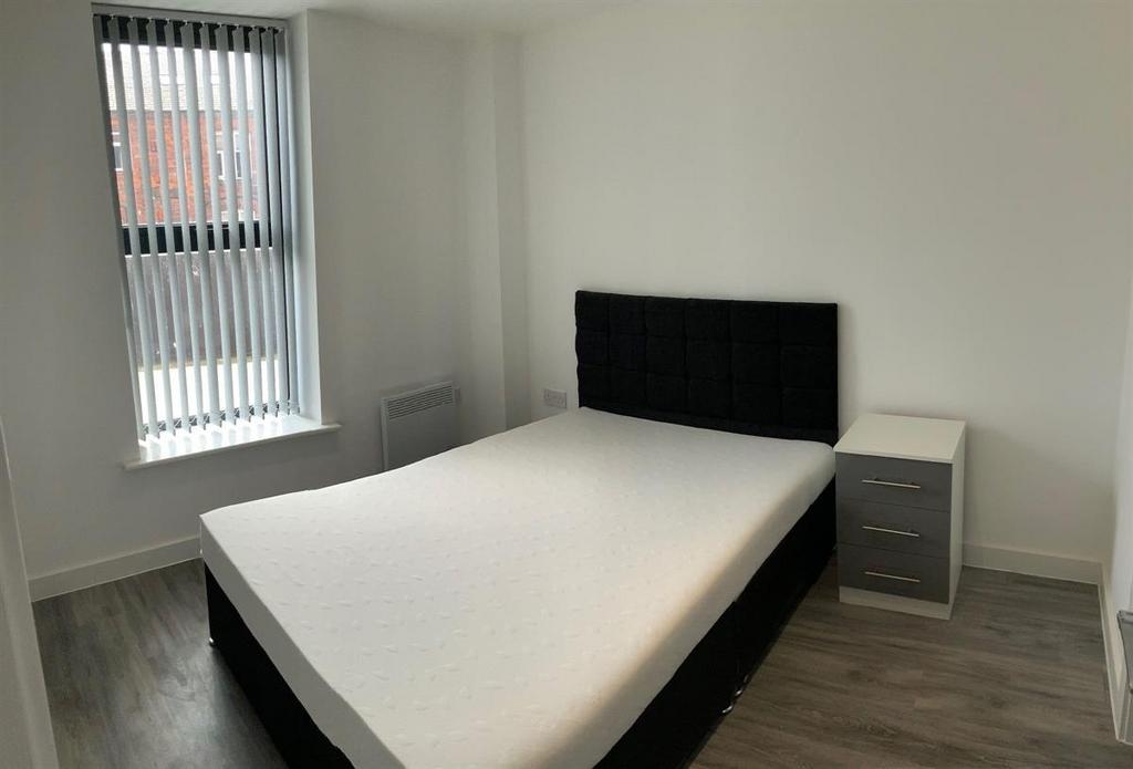 Bright bedroom with double bed and modern floor...