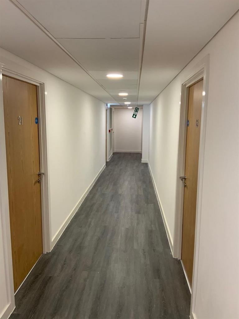 Bright communal corridor with modern flooring...