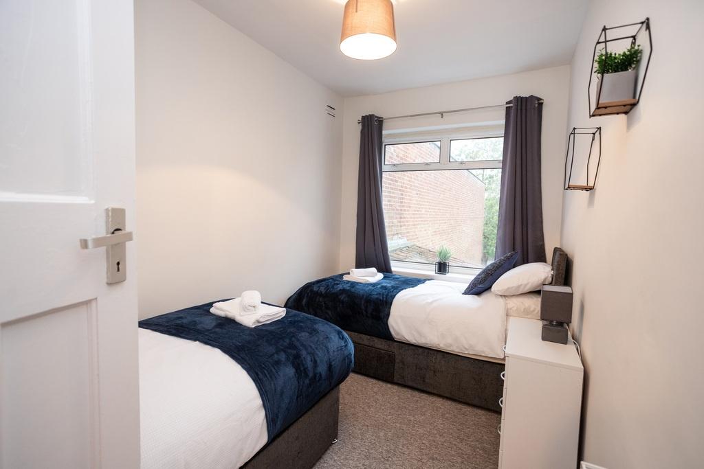 Bright, neatly presented twin bedroom with two ...