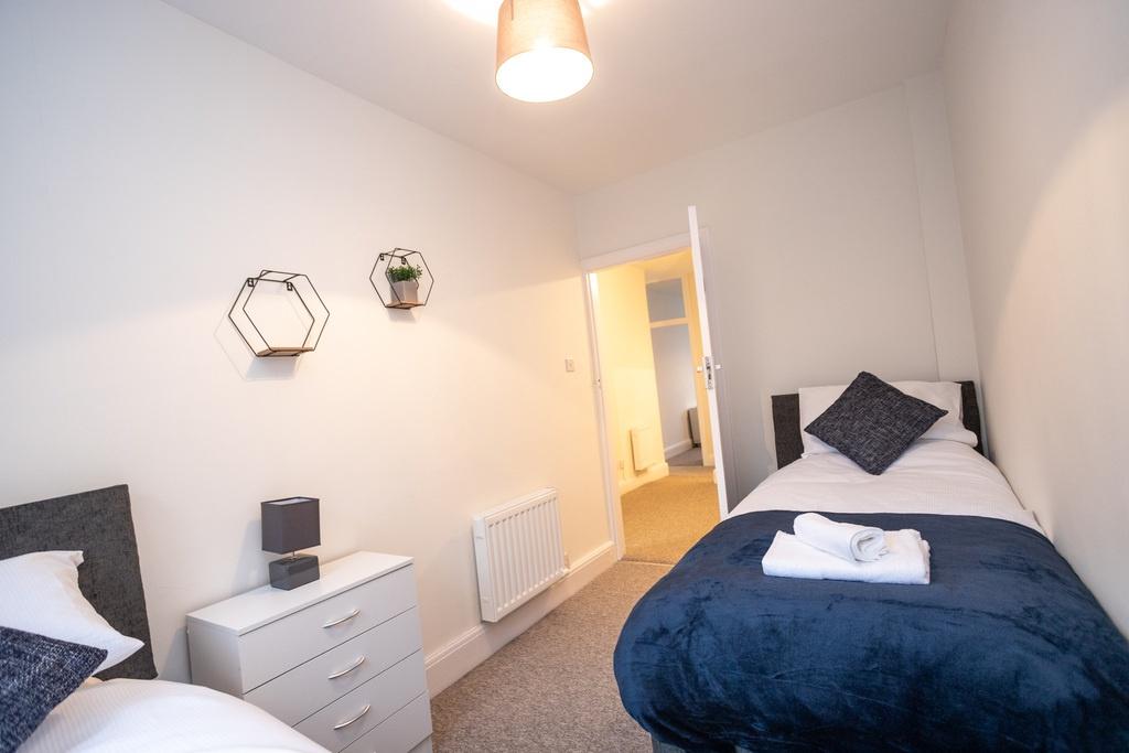 Bright, neatly presented twin bedroom with two ...