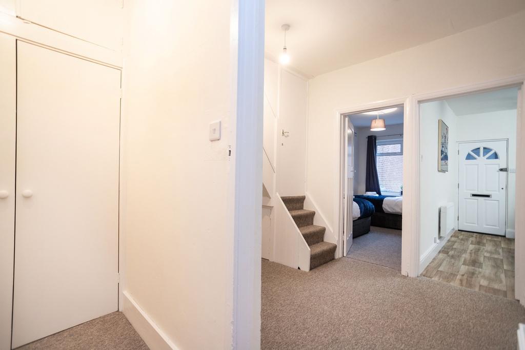 Bright, freshly painted entrance hallway with f...