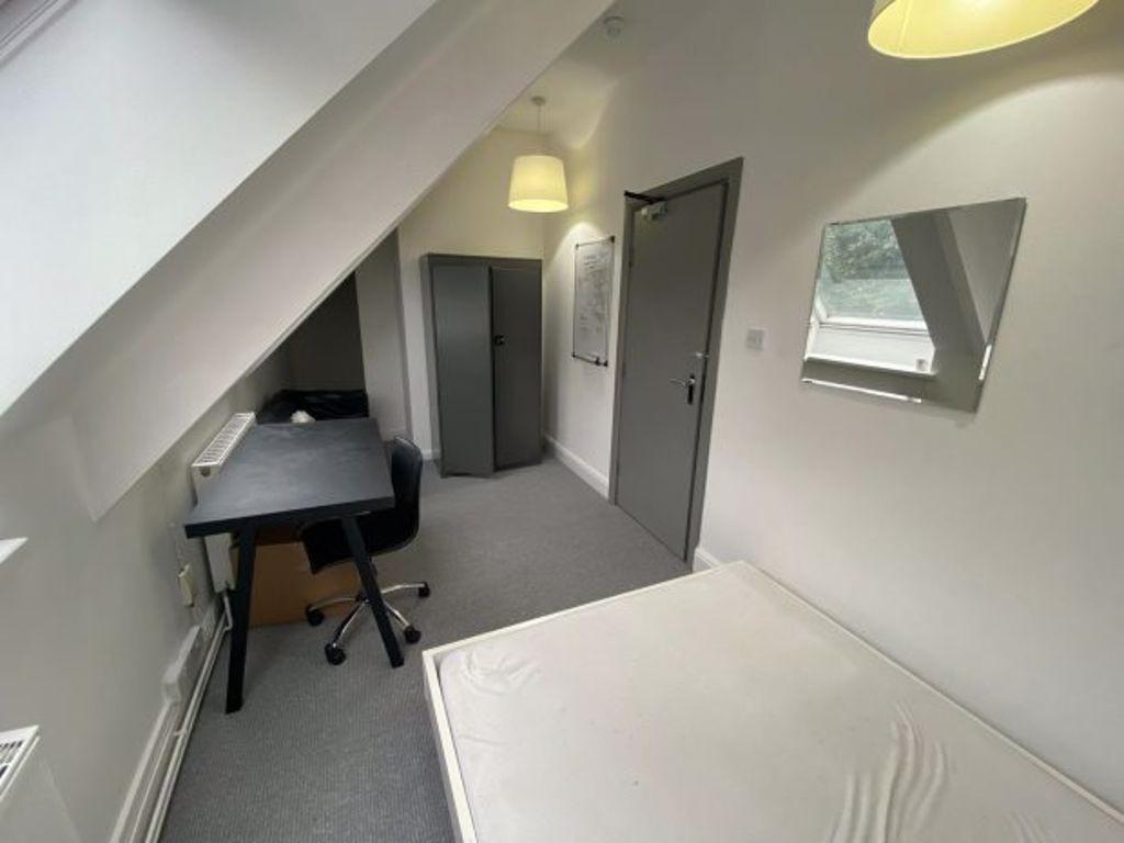 Bright, simply furnished single bedroom with a ...