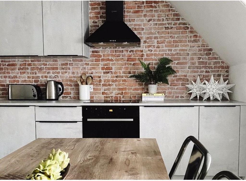 A modern and clean kitchen with ample natural l...