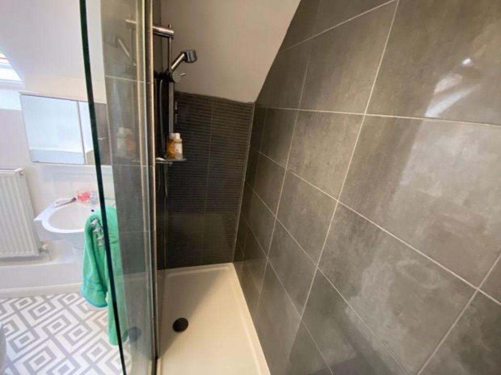 A modern, clean bathroom featuring a walk-in sh...