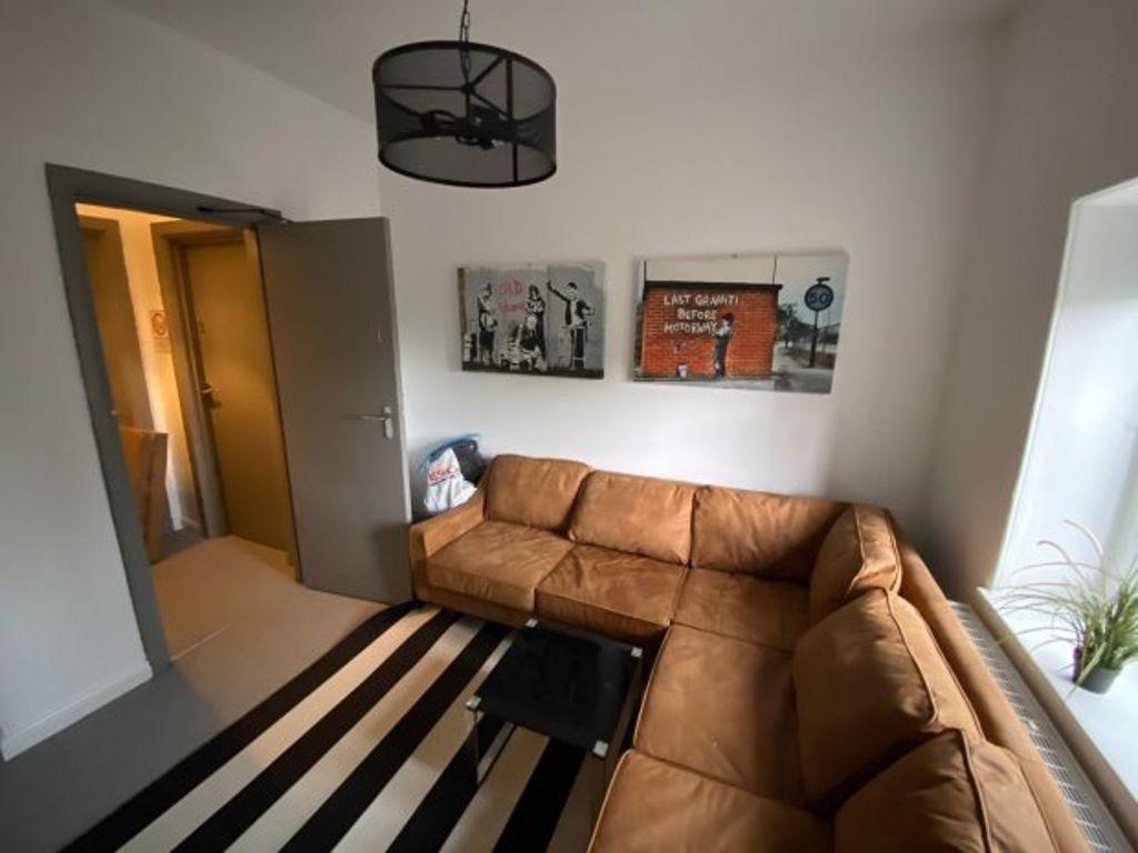 A spacious and inviting living room featuring a...