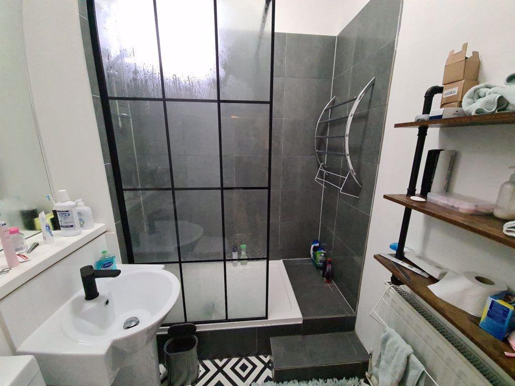 A clean and modern bathroom featuring a large s...