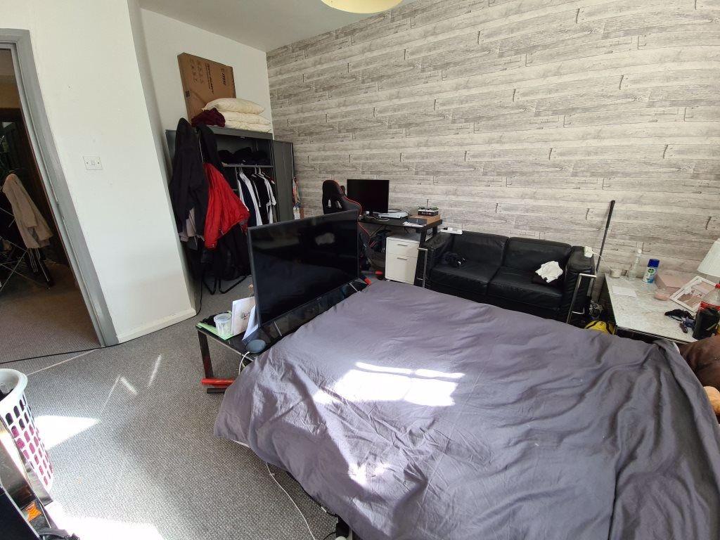 A bedroom featuring a double bed, wardrobe, and...