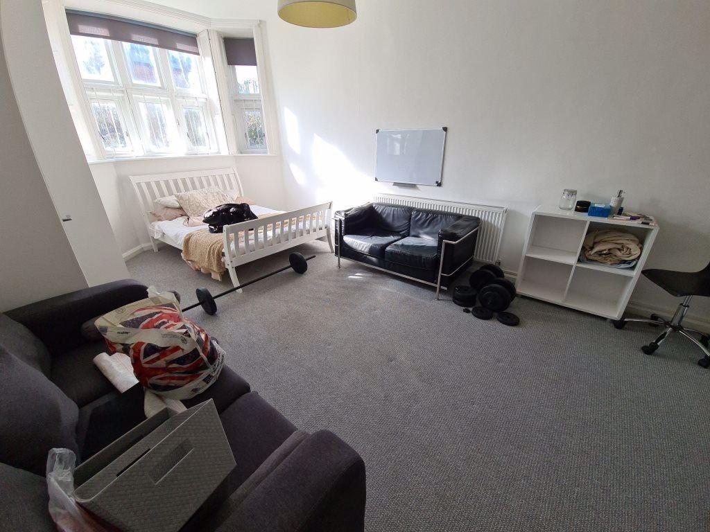 A well-lit living room with a comfortable sofa,...