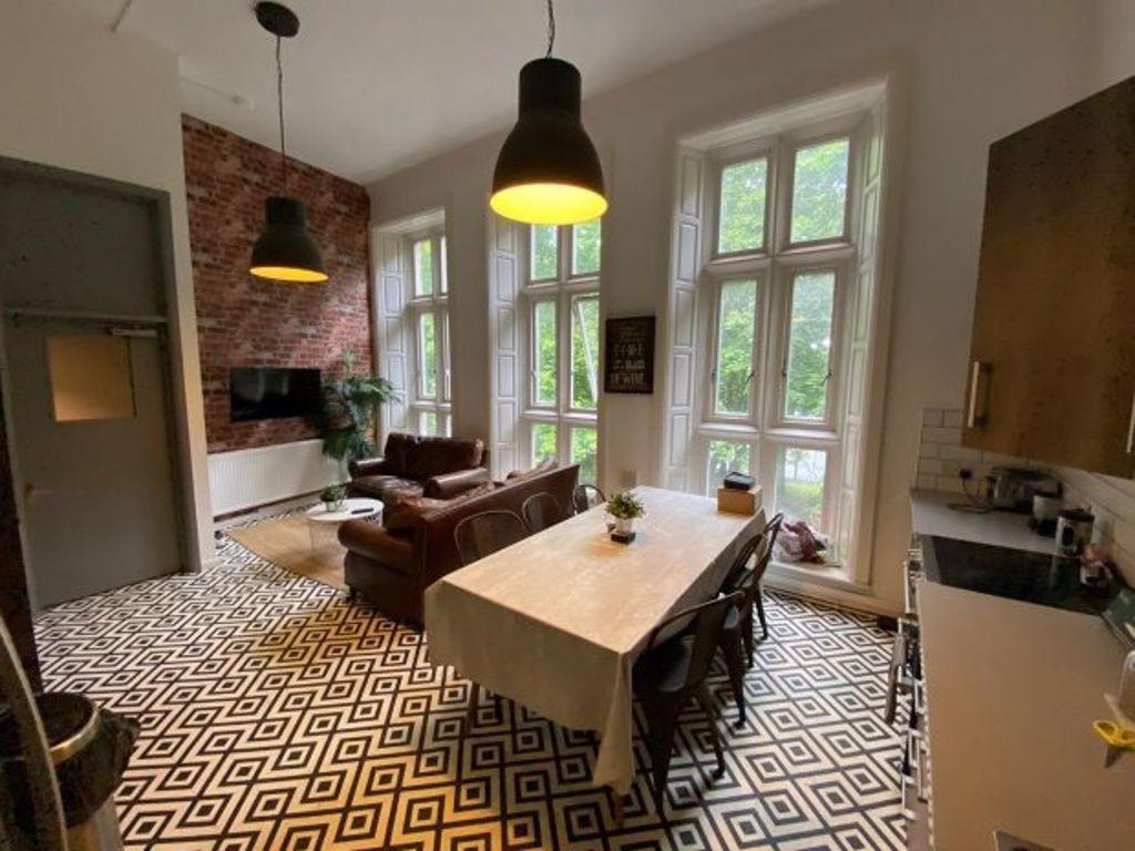 A stylish living room featuring a high ceiling ...