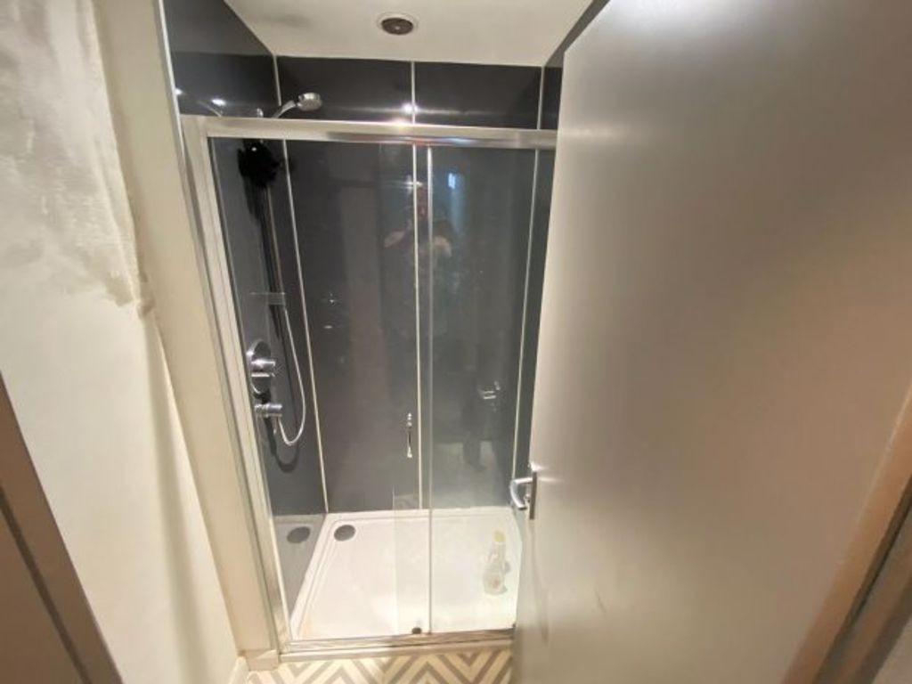 Modern bathroom suite featuring a clean glass-e...