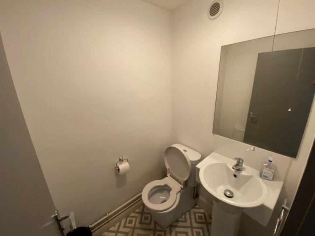 A clean and simple single toilet with neutral w...