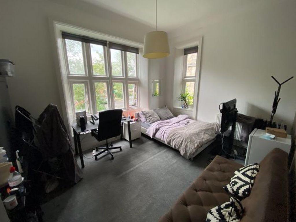 Bright and spacious bedroom featuring a large b...