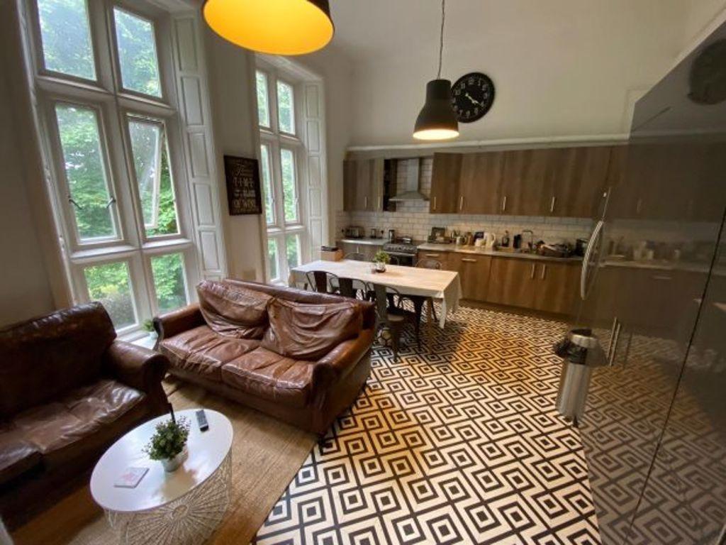 A bright and inviting kitchen featuring large w...