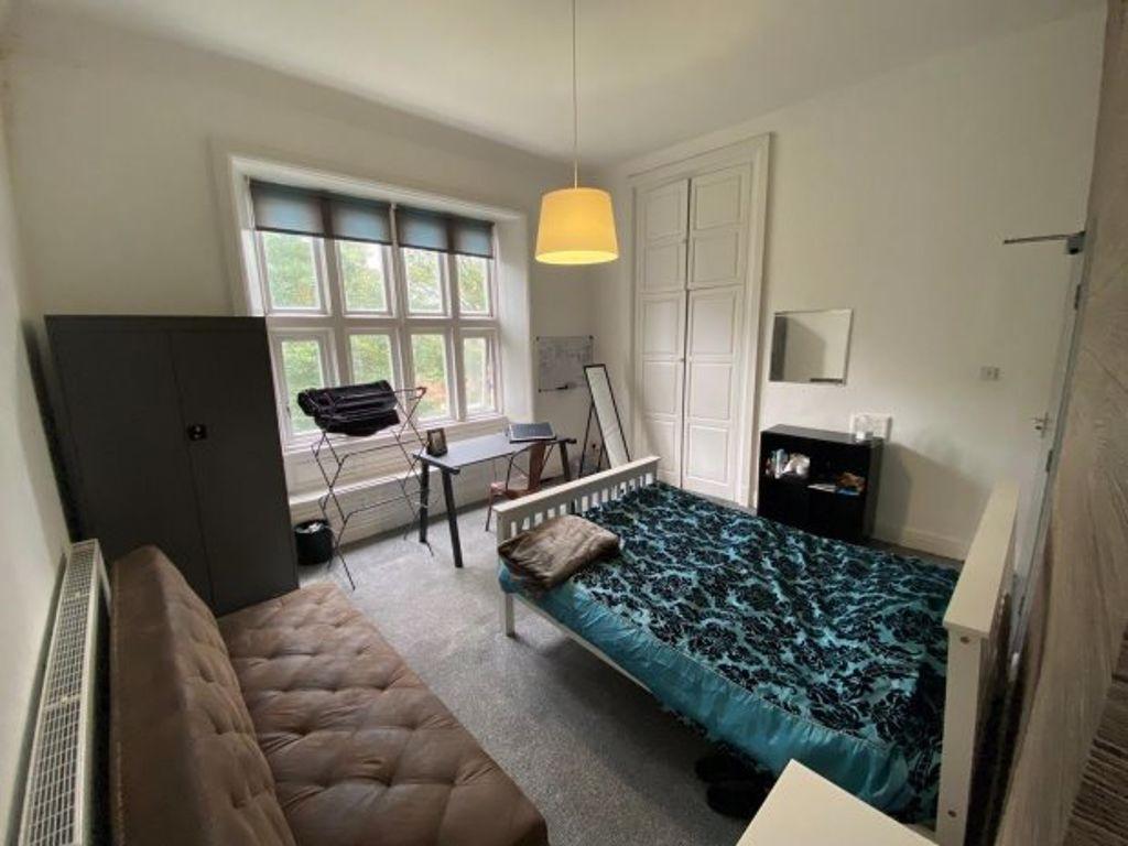 A cozy double bedroom featuring a large window ...