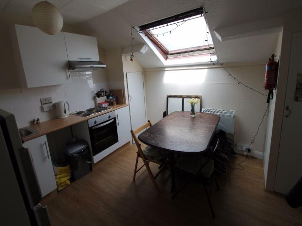 Bright studio-style kitchen with a dining table...