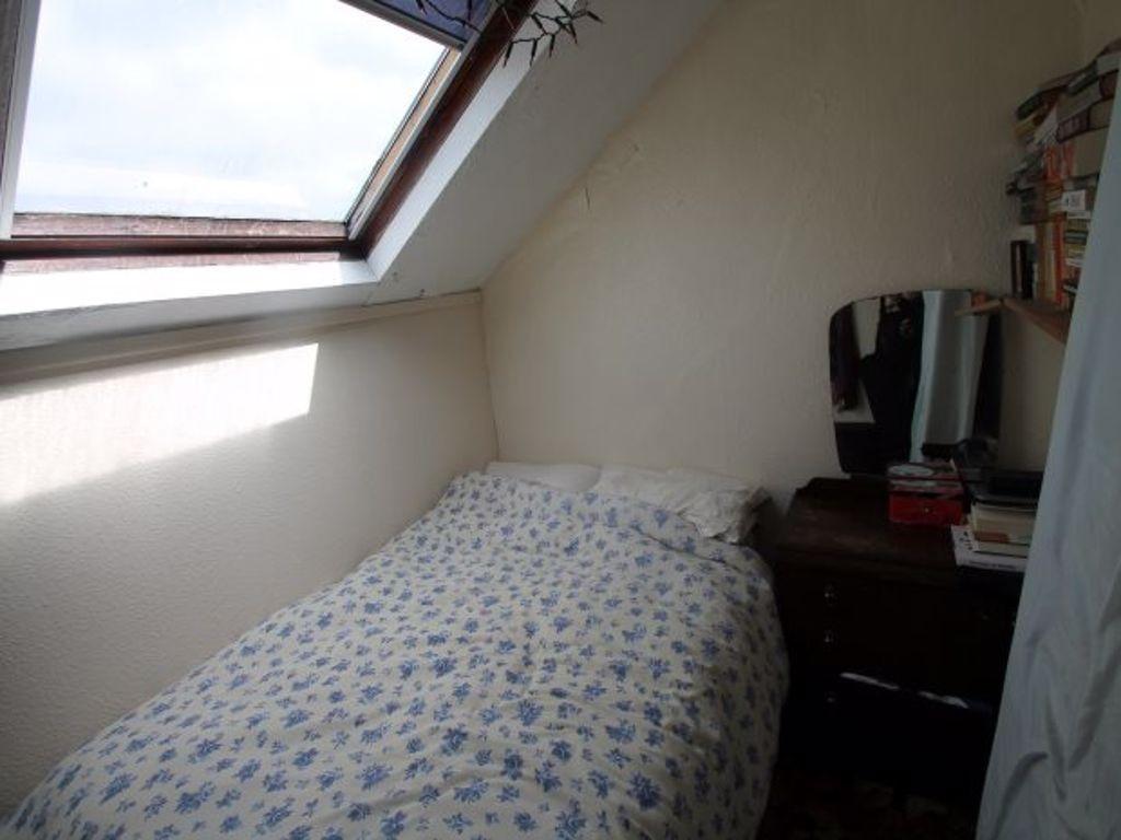 Cosy attic bedroom with a skylight providing na...