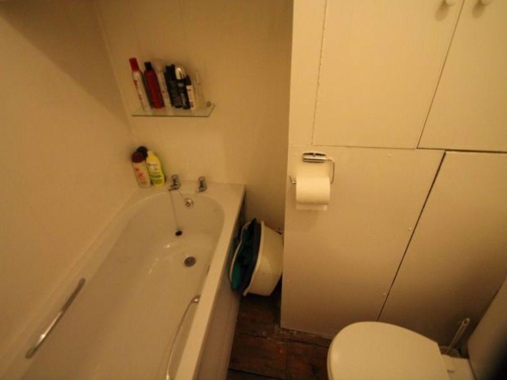 Compact, functional bathroom with a bathtub, fi...
