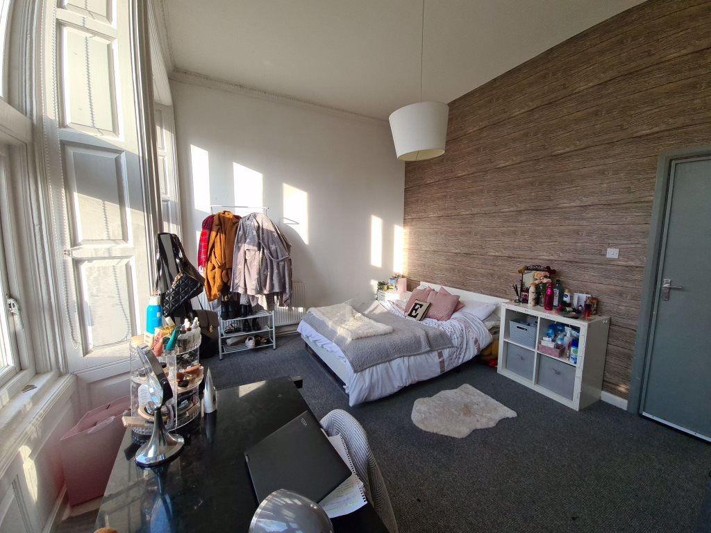 Bright and airy master bedroom featuring a cozy...