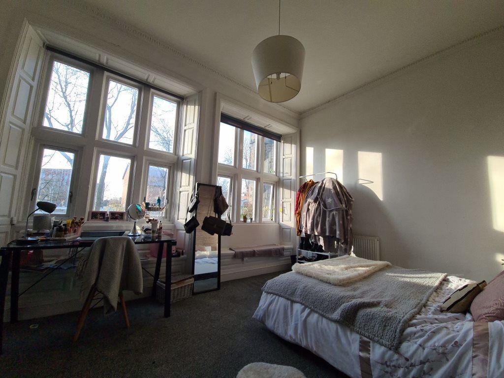 A bright and airy master bedroom featuring a la...