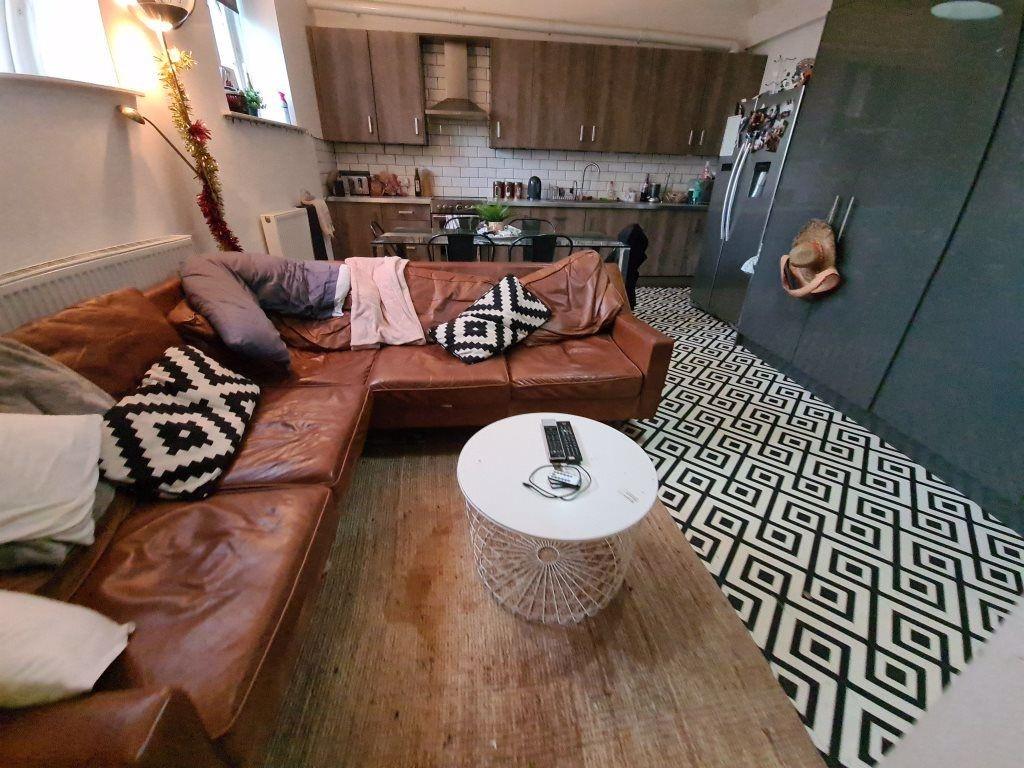 Spacious and stylish living room featuring a la...