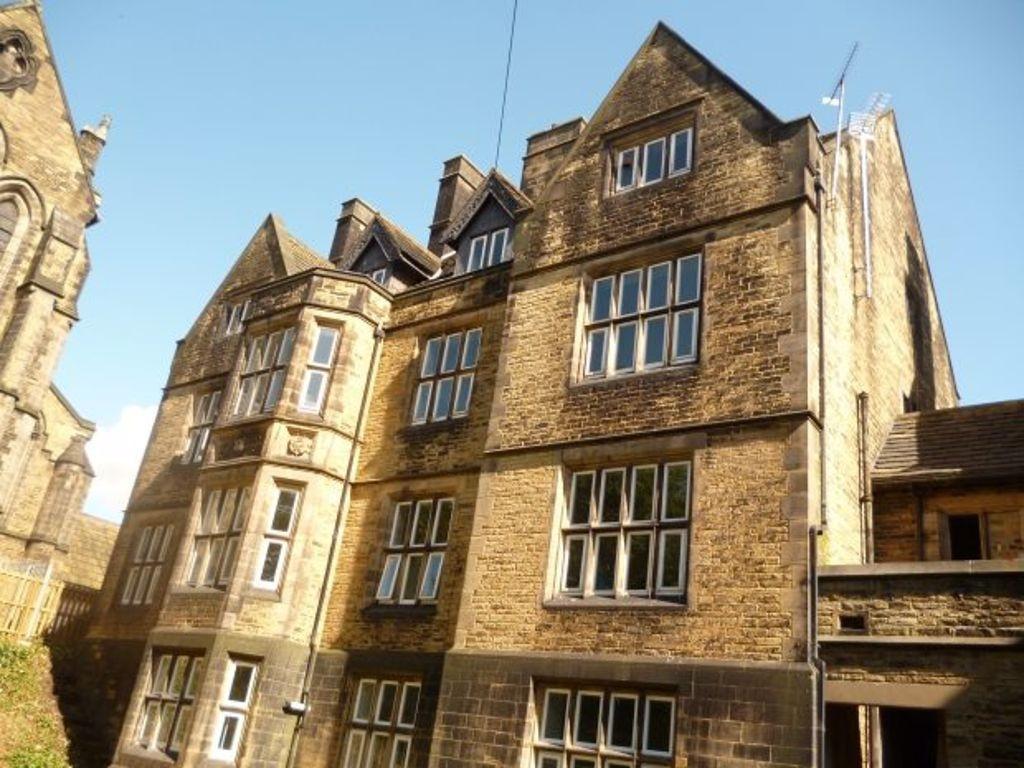 Historic stone building with large multi-pane w...