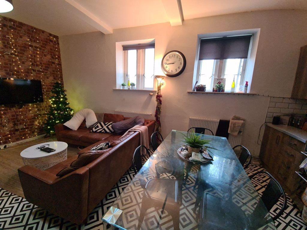 A cozy and stylish living room featuring a comf...