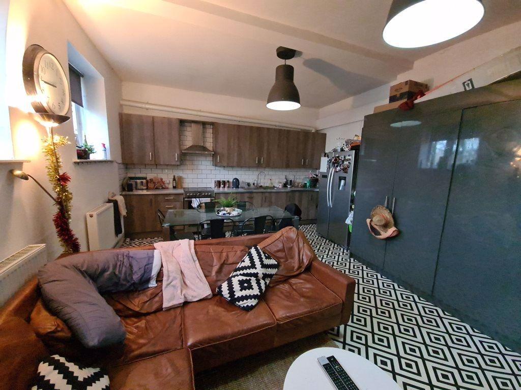 A cozy living room featuring a stylish brown le...