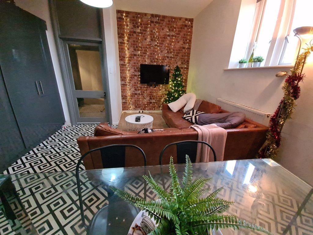 A cozy living room featuring a patterned carpet...