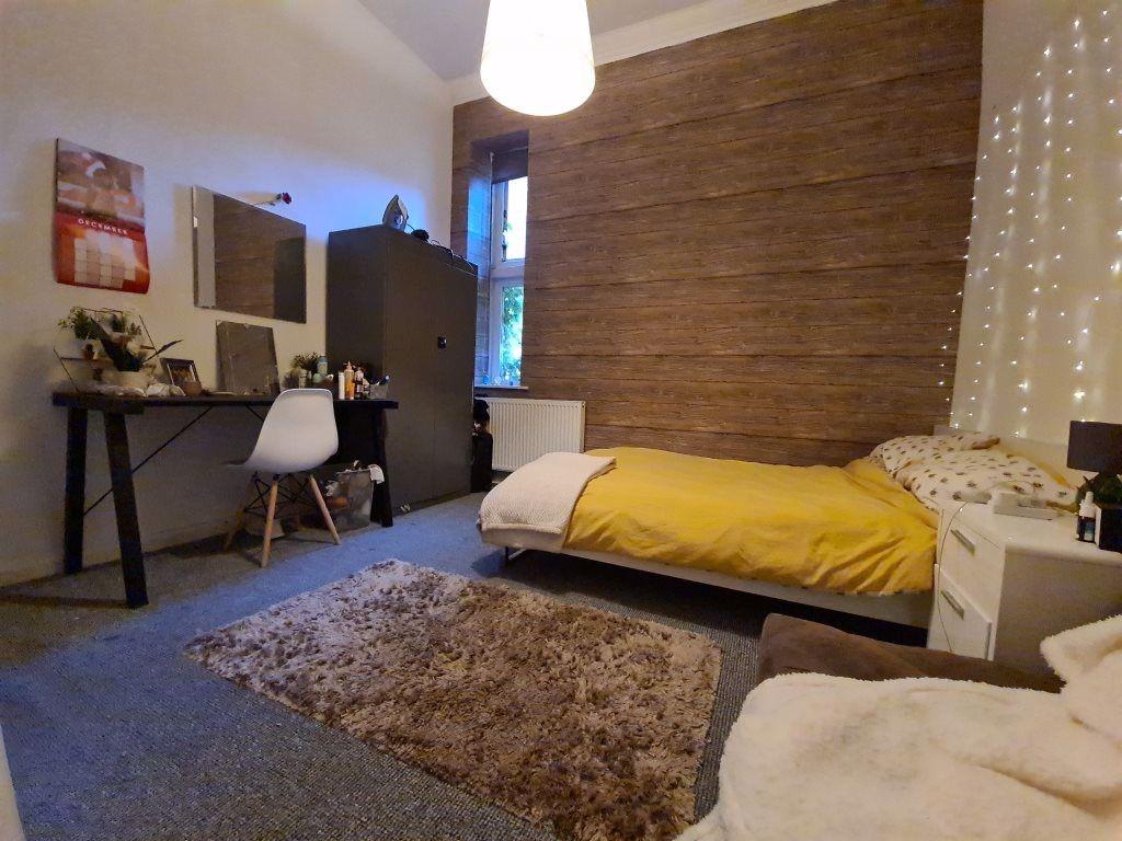 Cozy single bedroom featuring a comfortable bed...