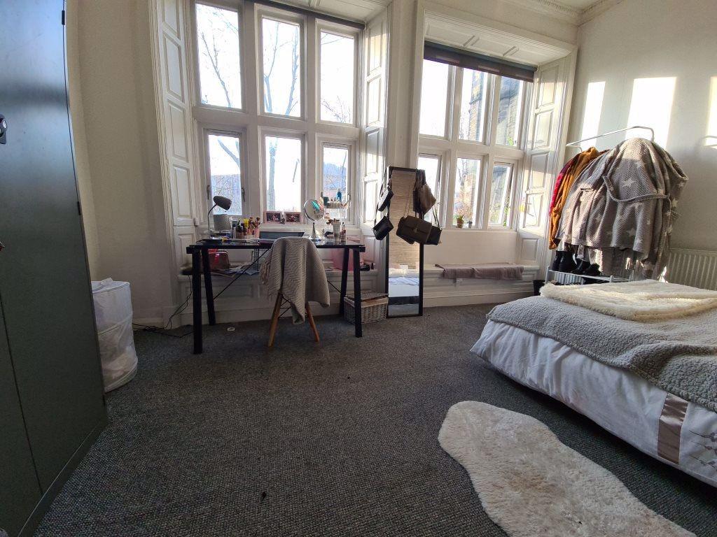Bright and spacious master bedroom featuring la...