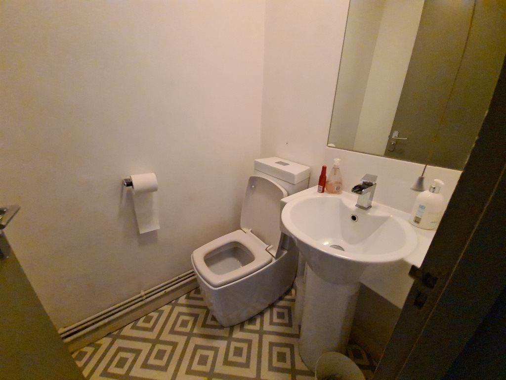 A compact and clean toilet space featuring a mo...