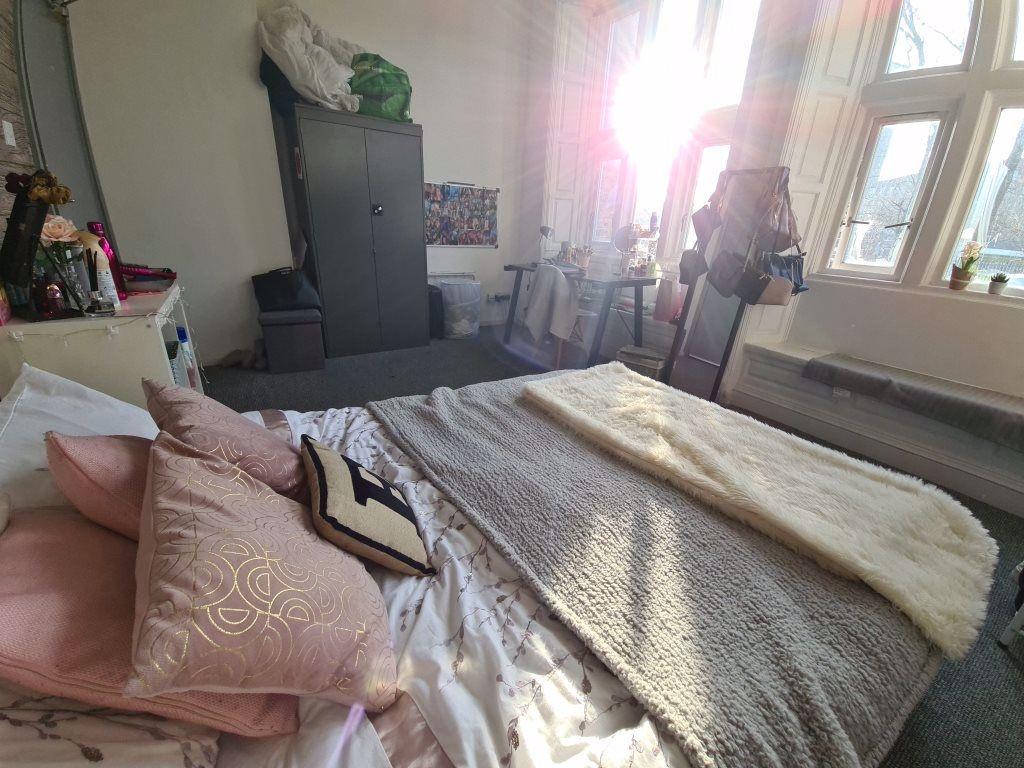 A bright and inviting master bedroom featuring ...