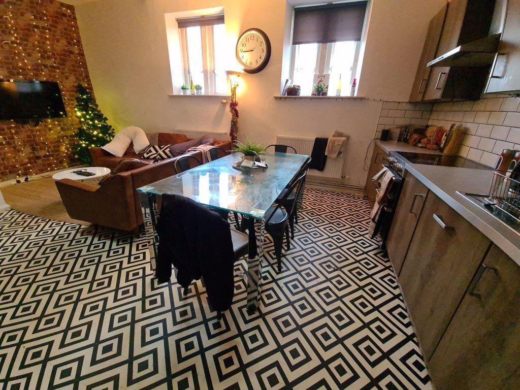 A contemporary living room featuring a patterne...