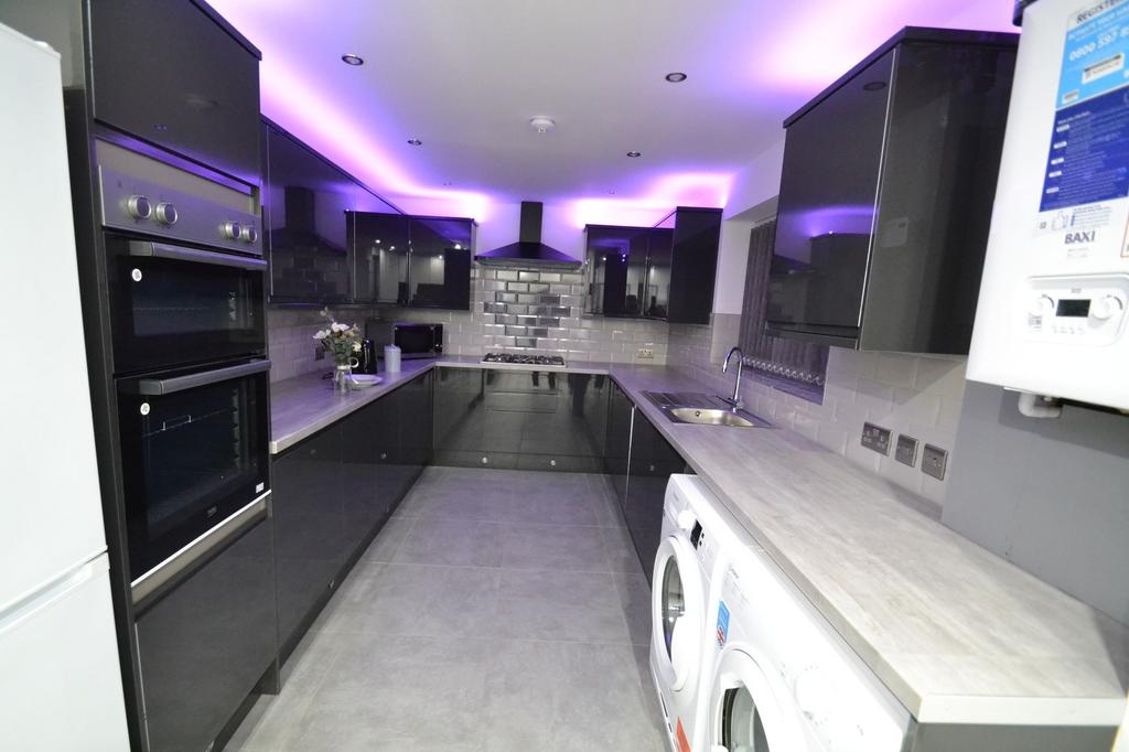 Modern galley kitchen with sleek grey cabinetry...