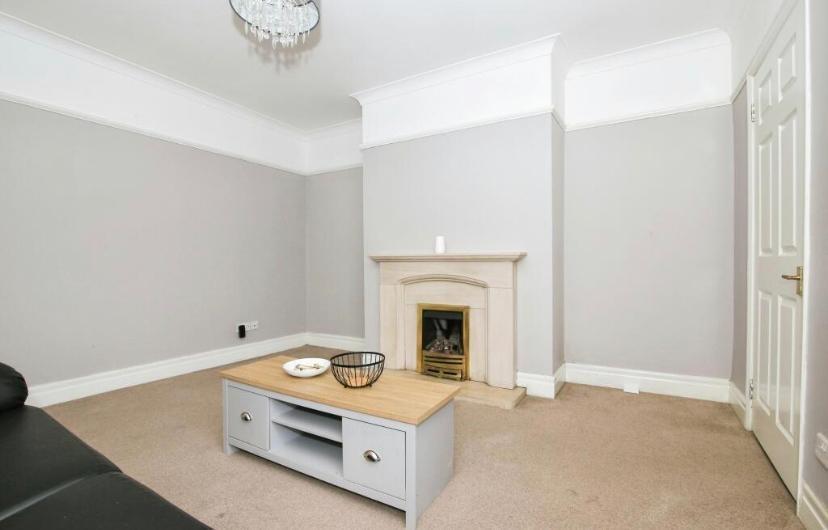 Bright, neutral living room with a decorative f...