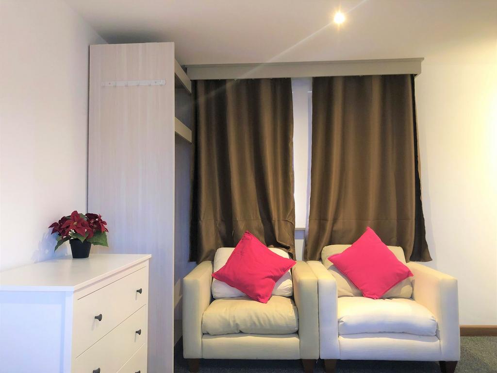 A cozy communal lounge featuring two comfortabl...
