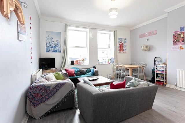 Bright, comfy living room with sofas and study ...