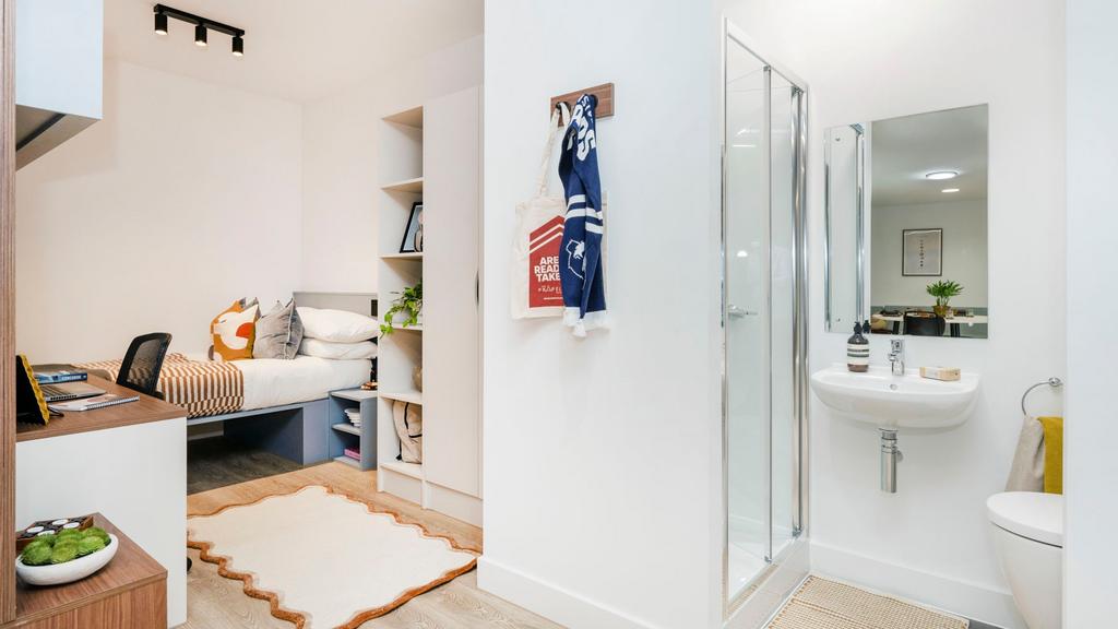 Bright, modern en-suite bedroom with a comforta...