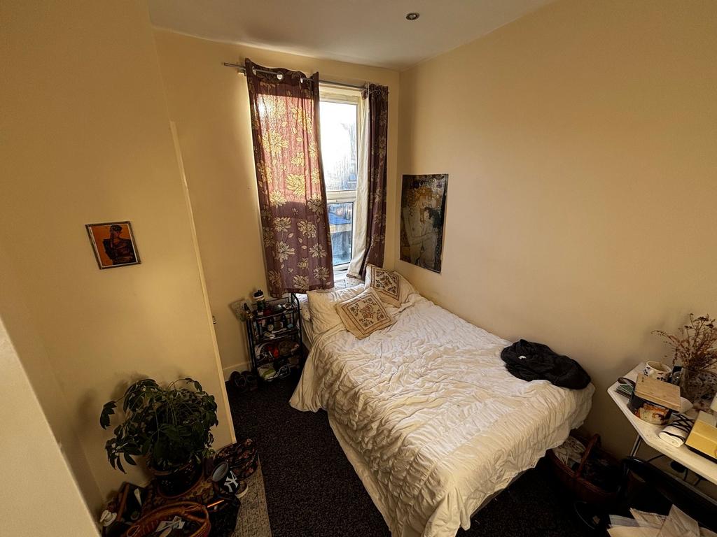 Cosy double bedroom with a comfortable white be...