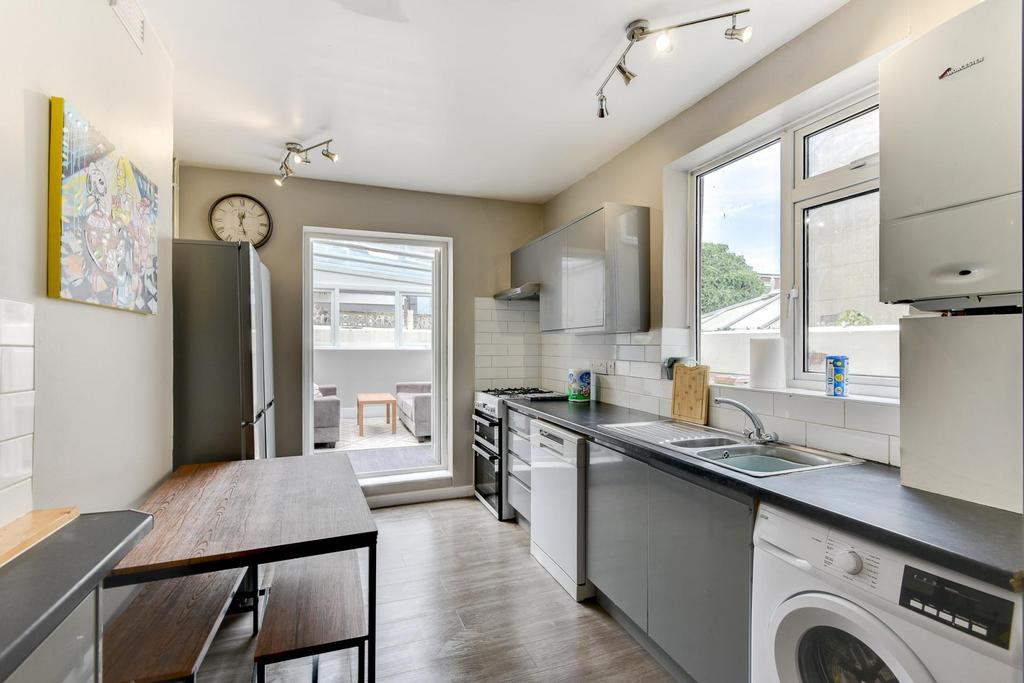Bright, modern galley kitchen with contemporary...