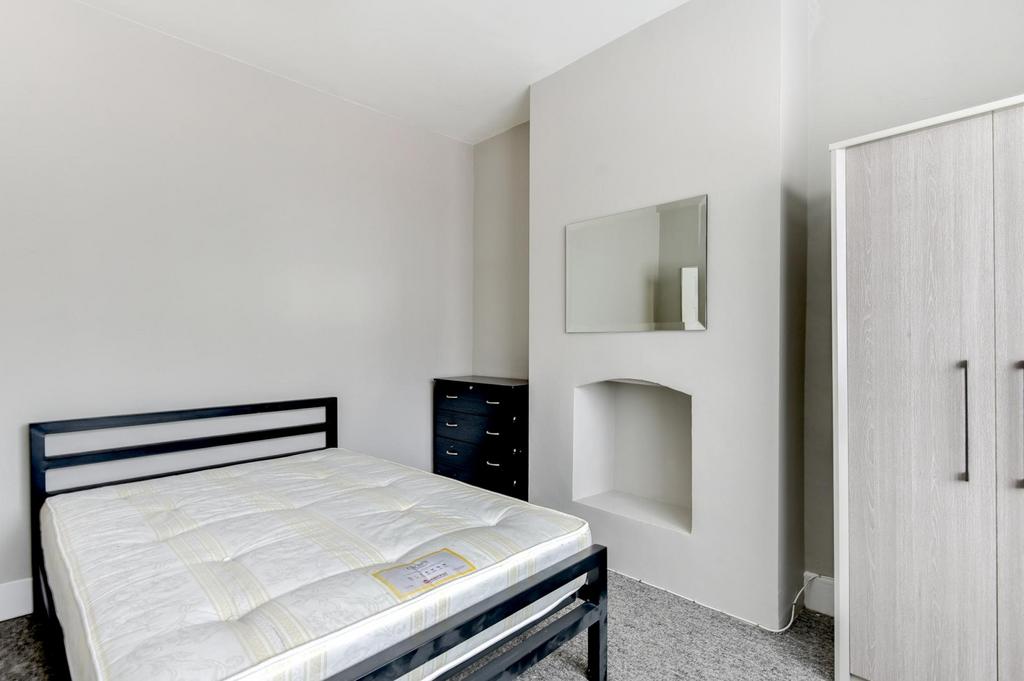 A spacious and clean master bedroom featuring a...