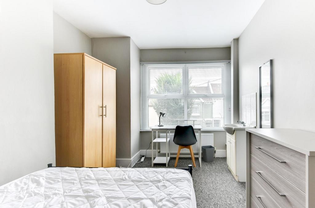 A bright, well-maintained bedroom featuring a l...