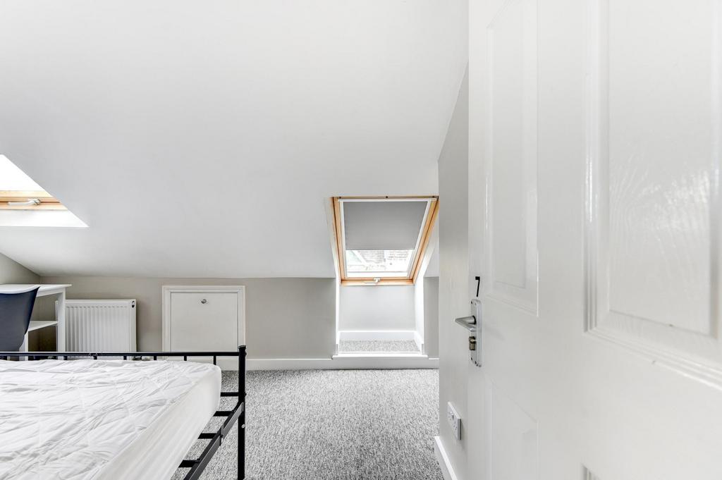 Bright attic double bedroom with a pitched ceil...