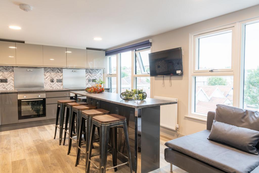 Bright, modern open-plan kitchen with a long br...