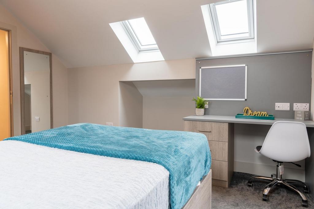 Bright, modern attic double bedroom with skylig...