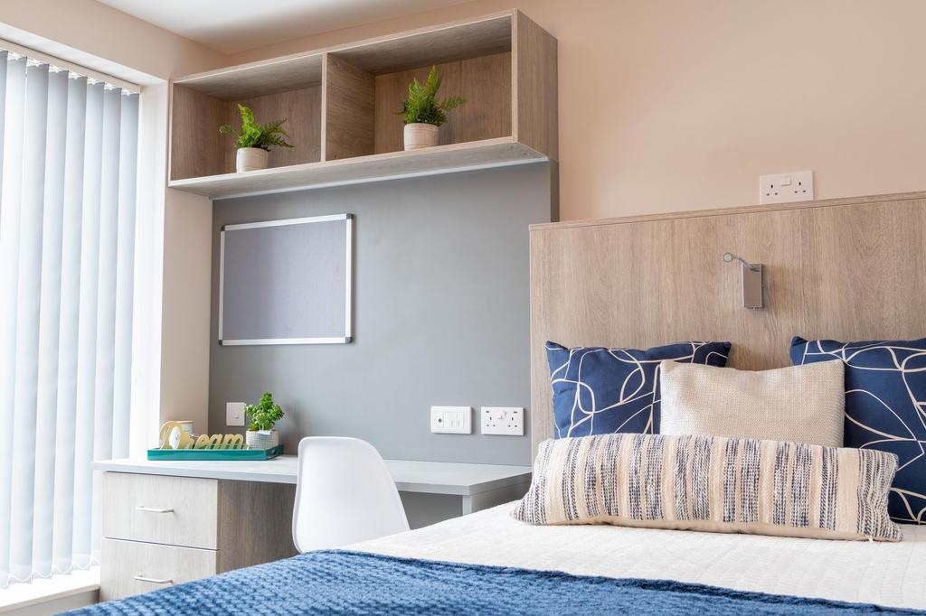 Bright, modern bedroom with a comfortable doubl...