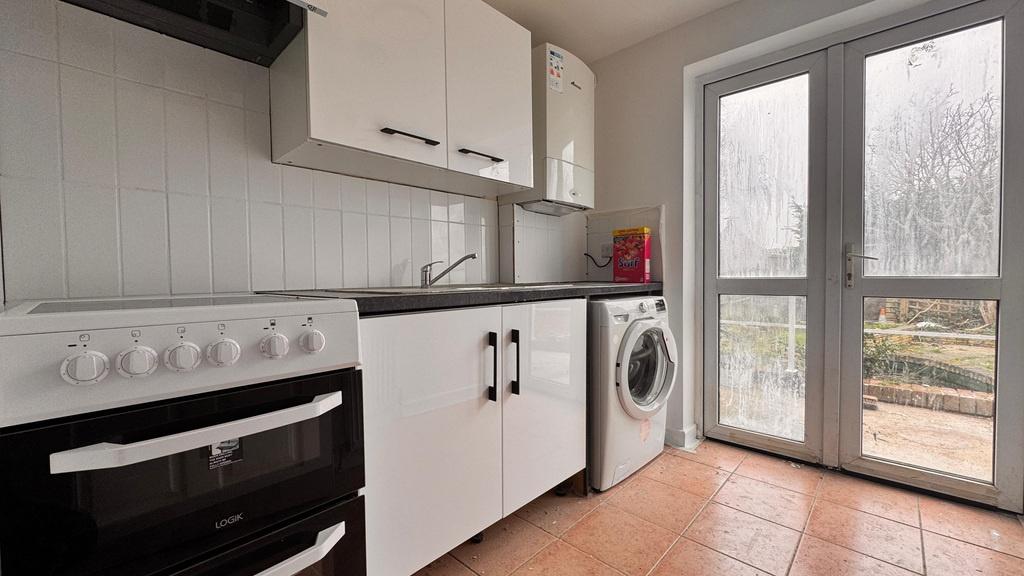 Bright fitted kitchen with patio doors...