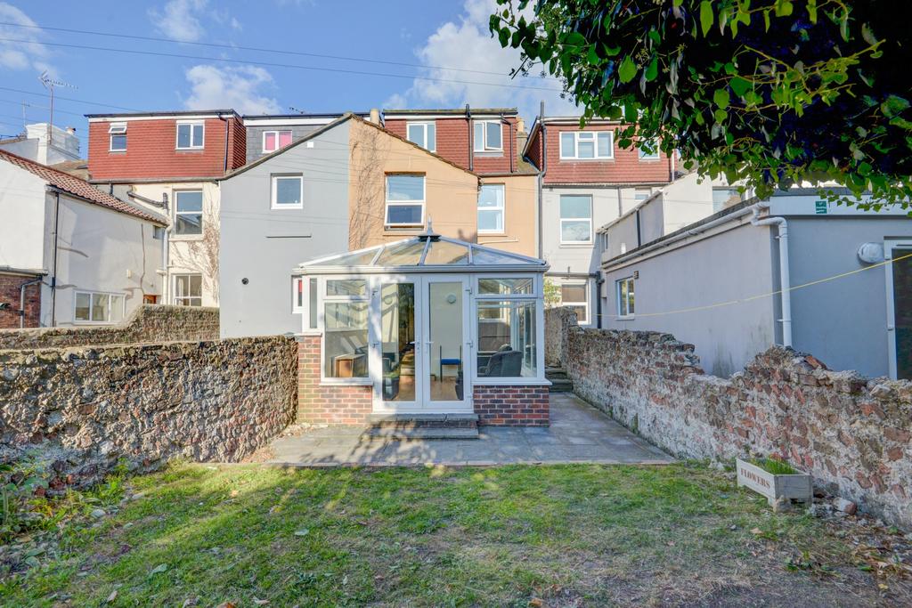 Well-kept rear garden with a paved patio and a ...
