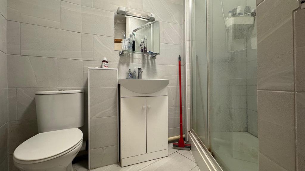 Modern tiled bathroom with shower and vanity...